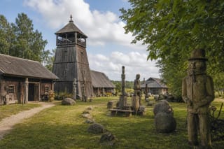 Adomas Petrauskas Museum homestead with a wooden tower and collected stones in Uoginiai