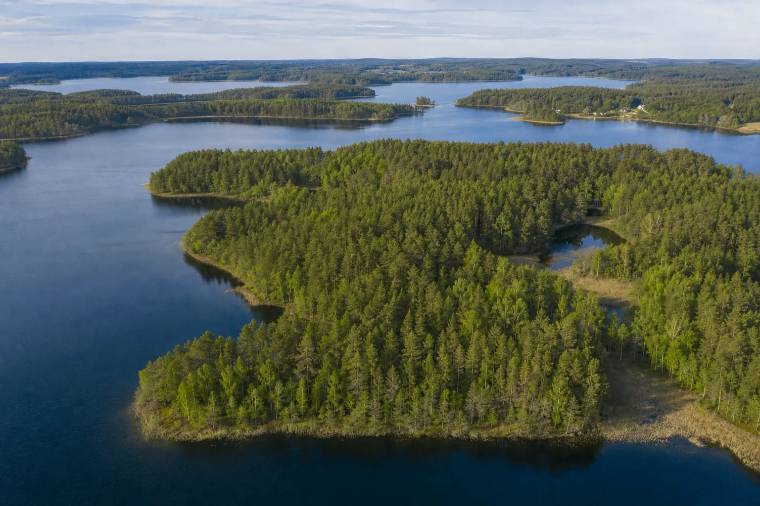 Chain of Aukštaitija National Park lakes among pine forests, islands, and small villages
