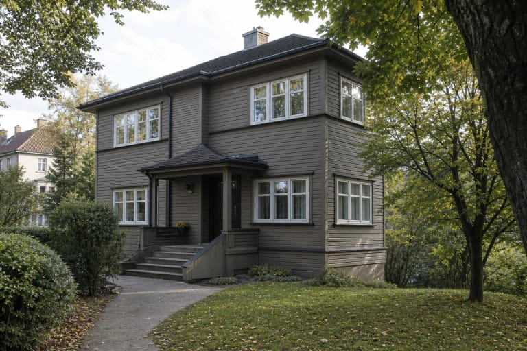 Grey timber modernist Balys and Vanda Sruoga House in a green Žaliakalnis garden