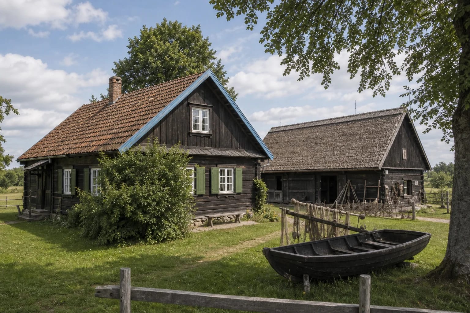 Old wooden Pamarys fisherman's homestead in Rusnė with a granary and cowshed