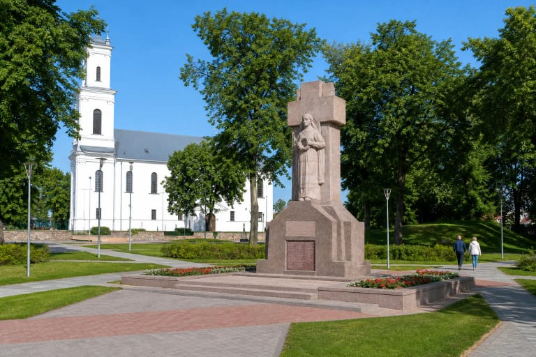 Monument to Those Who Died for Lithuanian Independence in Biržai Independence Square with the Church of St John the Baptist beyond
