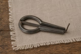 A metal dambrelis on linen as a Lithuanian folk idiophone