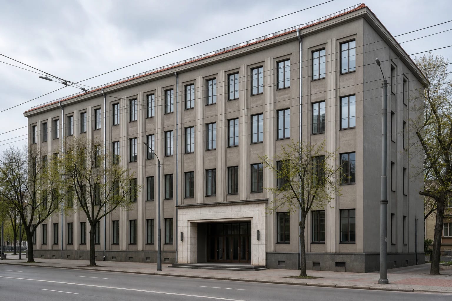 Strict grey modernist facade of the Labour Palace in Kaunas with vertical ribs and a light entrance portal