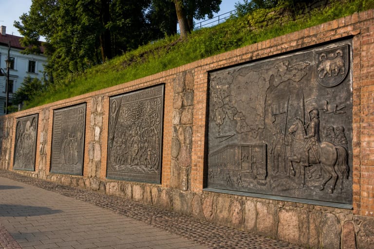 Didžiosios žemaičių sienos bronzinės istorijos plokštės raudonų plytų atraminėje sienoje Telšiuose