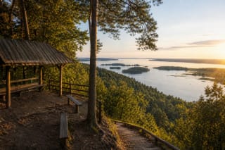 Mergakalnis viewpoint at Dovainonys Outcrop above Kauno Marios with forest and water panorama