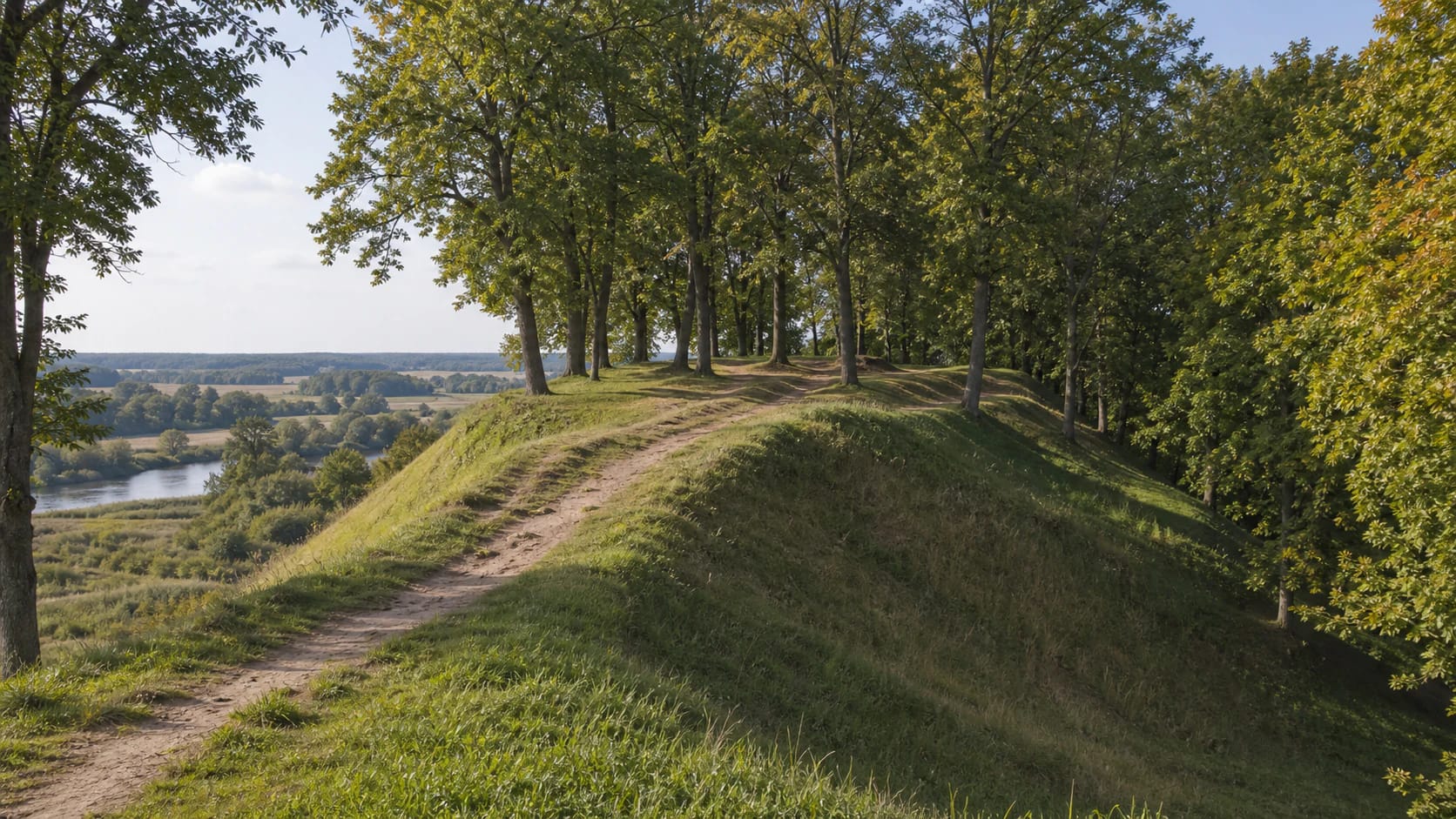 Dovilai Hillfort above the Minija valley with wooded slopes