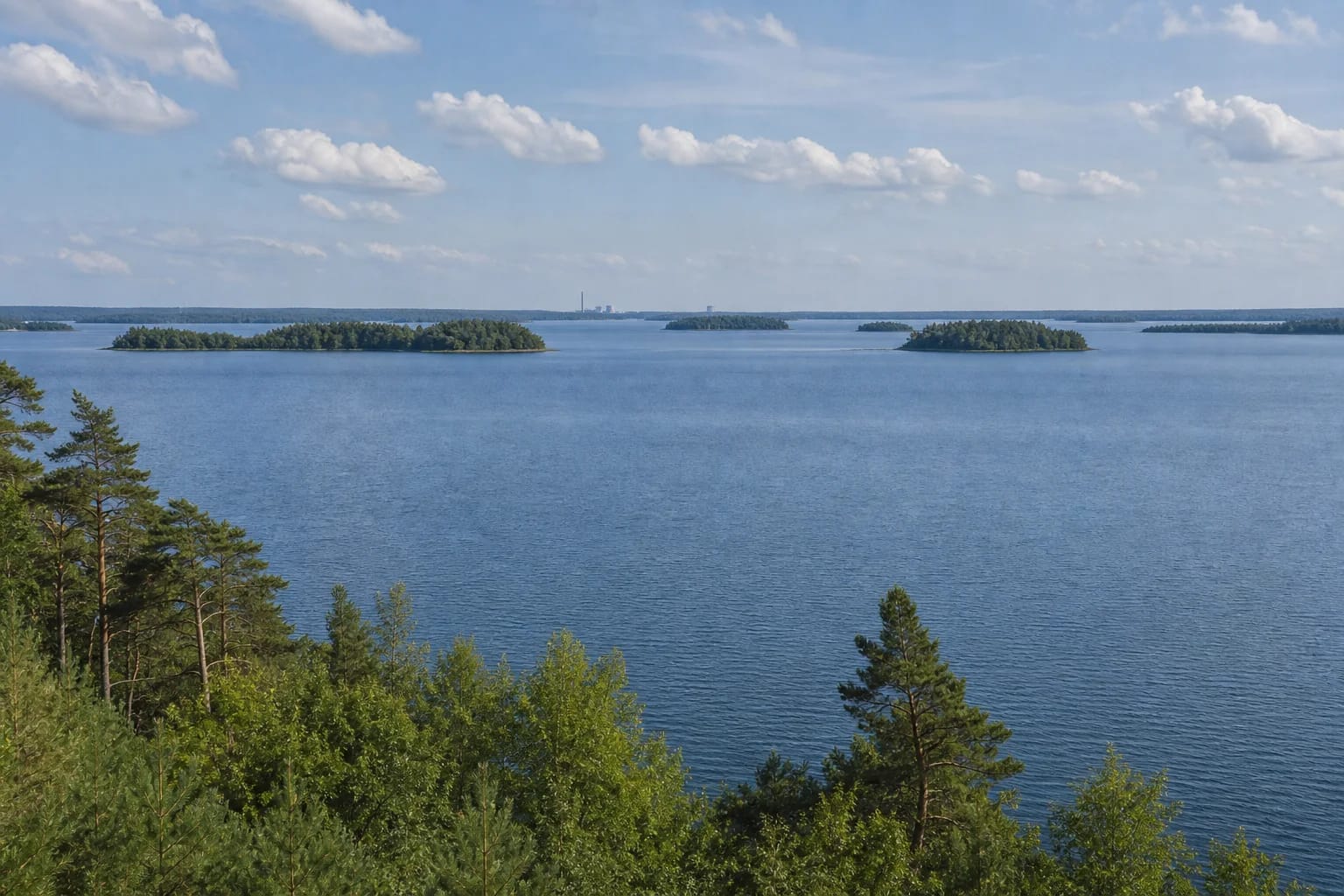 Open waters of Lake Drūkšiai with islands and a forested shore in summer light near Visaginas