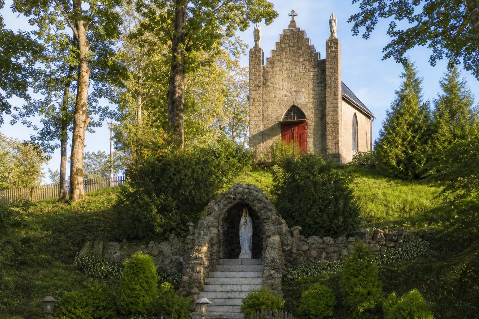 Inkakliai chapel on a green slope above the Lourdes grotto and steps