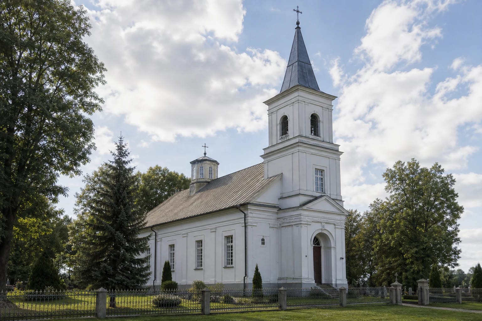 White Išlaužas Church of Mary Help of Christians with its side bell tower and octagonal roof dome