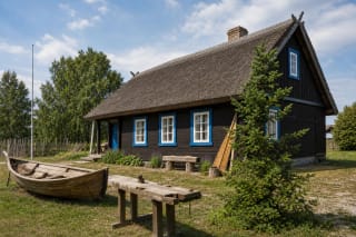 Wooden house of J. Gižas Ethnographic Homestead in Dreverna with boatbuilding details in the yard