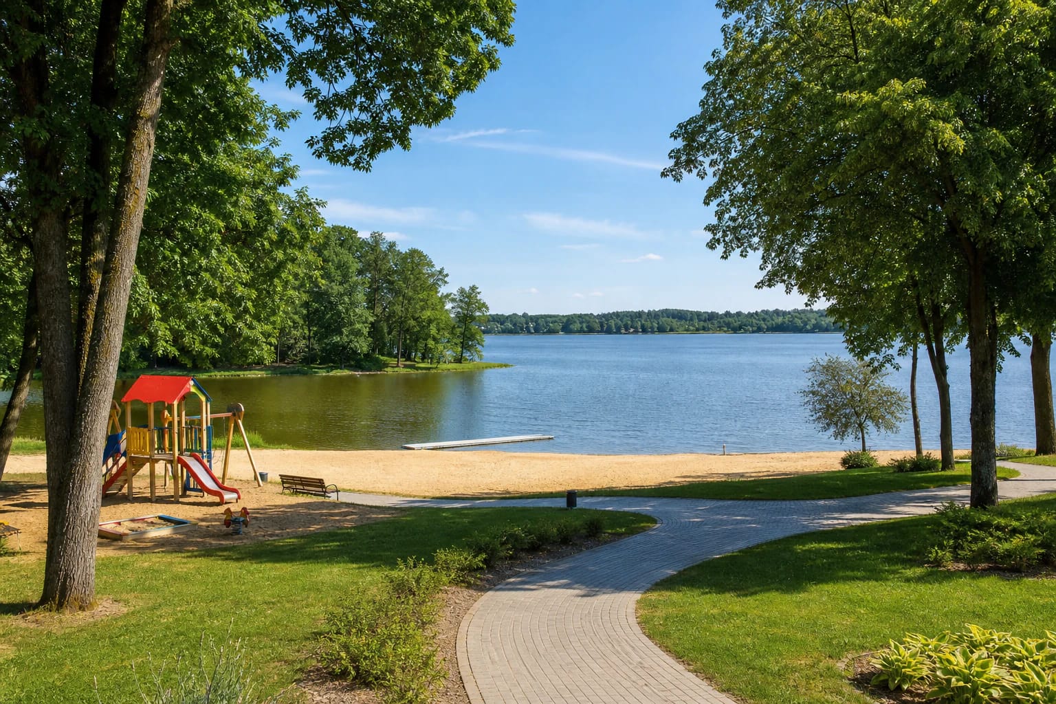 Jieznas Lake Beach with a children’s playground, paths, and a tree-lined shore
