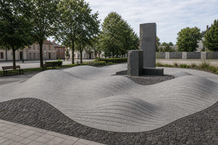 Granite-wave memorial with Jewish family names in Jurbarkas Synagogue Square