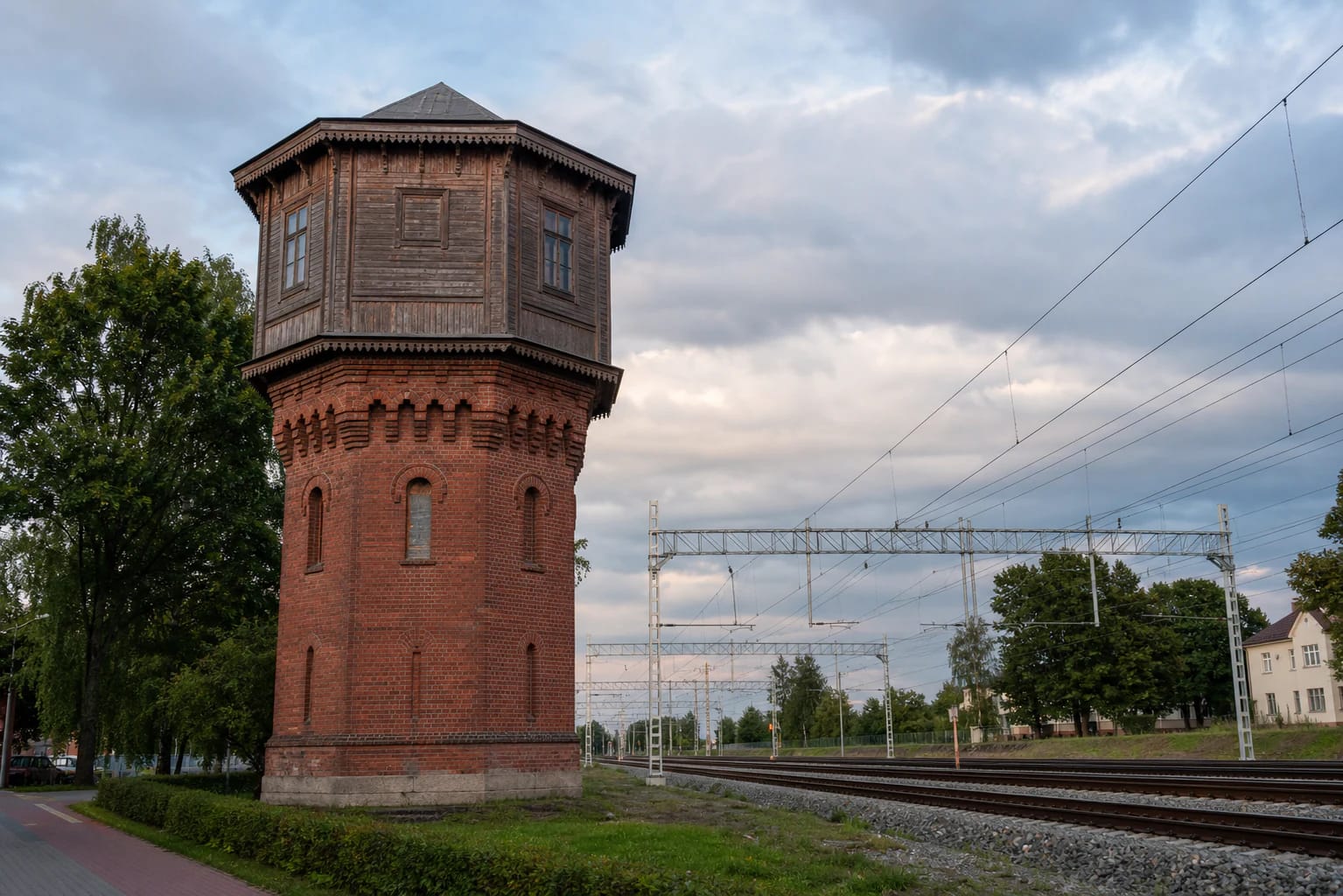 Red-brick Kaišiadorys Railway Station Water Tower with a timber upper volume beside the tracks