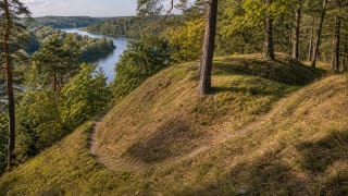 Wooded Karmazinai Hillfort in the valley landscape of Neris Regional Park