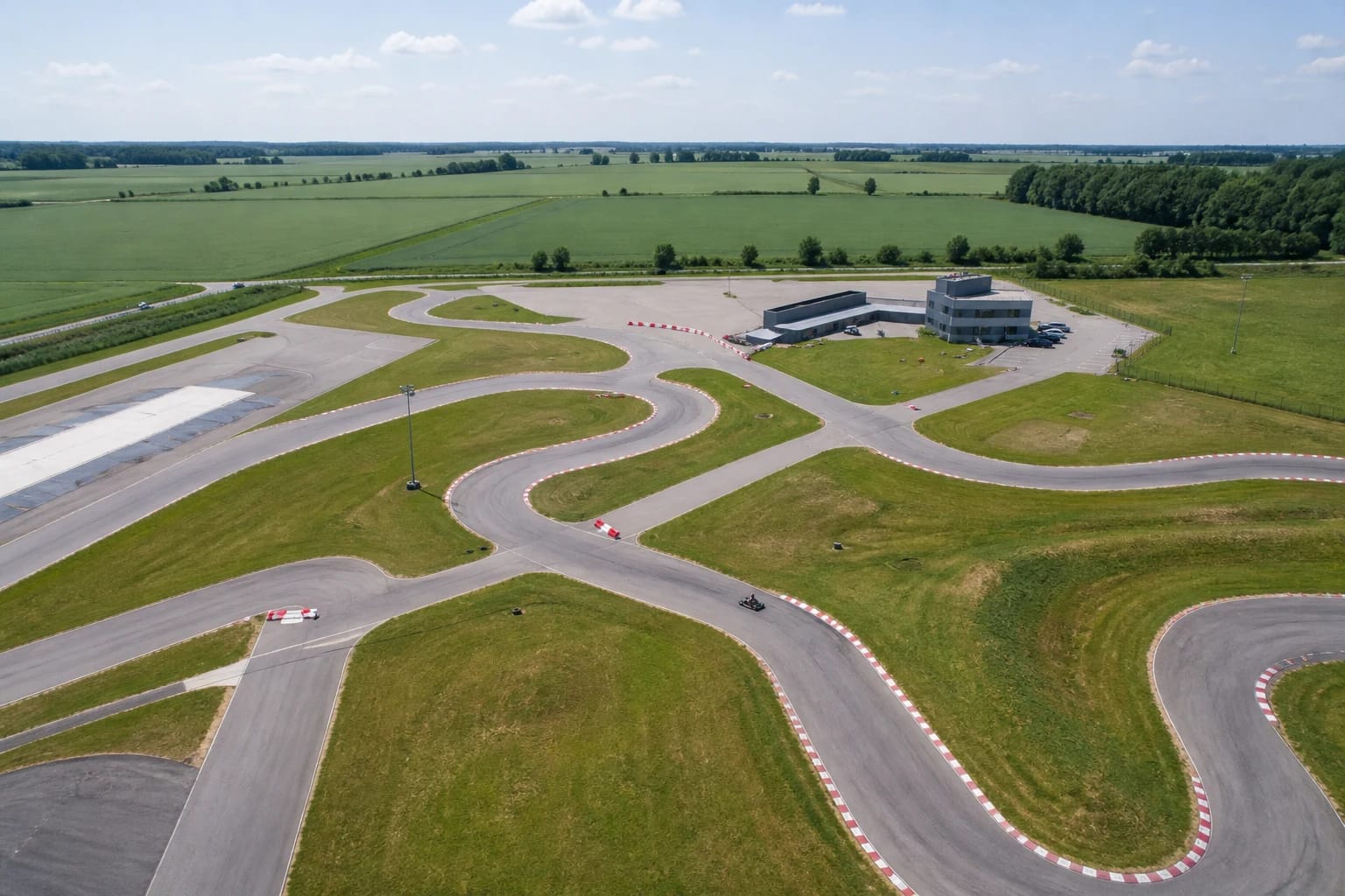 Winding KART3 outdoor asphalt circuit among green fields of Šiauliai District