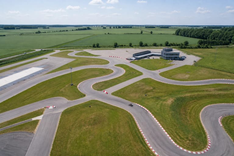 Winding KART3 outdoor asphalt circuit among green fields of Šiauliai District