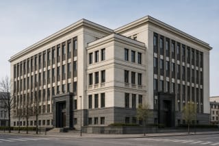Corner facade of Kaunas County Municipality Palace with light walls, dark pilasters, and a granite portal