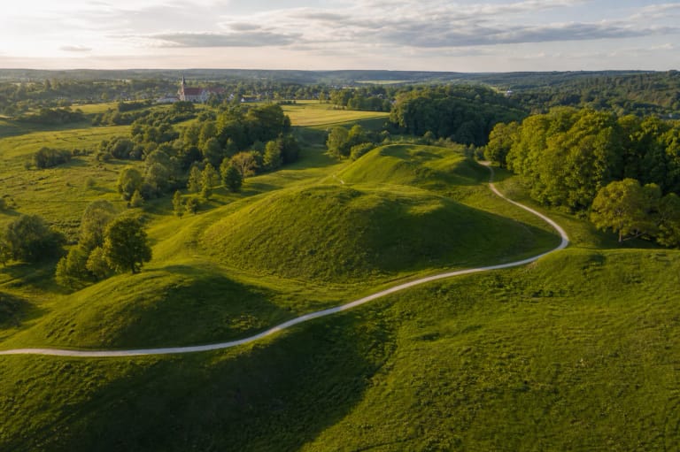 Green hillforts of Kernavė Archaeological Site and paths in Pajauta Valley in summer light