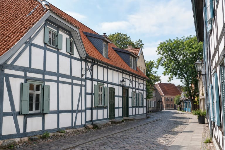 Half-timbered buildings of Klaipėda Old Town with red-tile roofs and a cobbled street