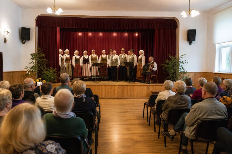 Kretingalė Culture Centre hall with local folk performers on stage