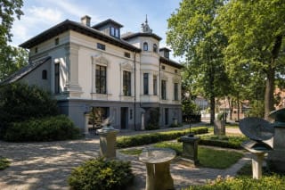 Historic nineteenth-century villa of the Clock Museum in Klaipėda with sundials arranged in the courtyard