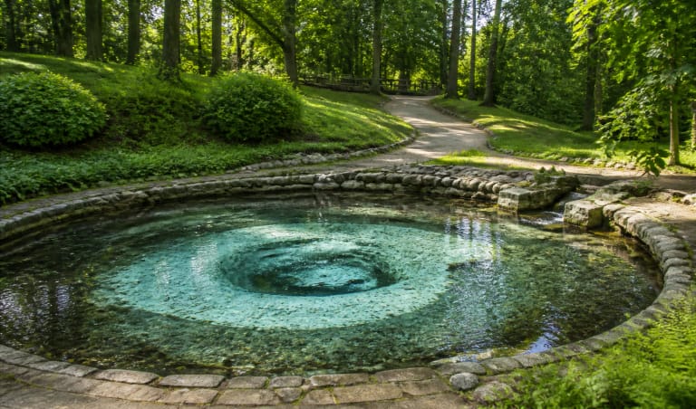Smardonė Spring basin in Likėnai Park among trees and paths