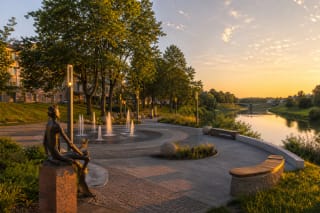 Paths, fountains, Šešupė riverbank, and evening lighting in Marijampolė Poetry Park