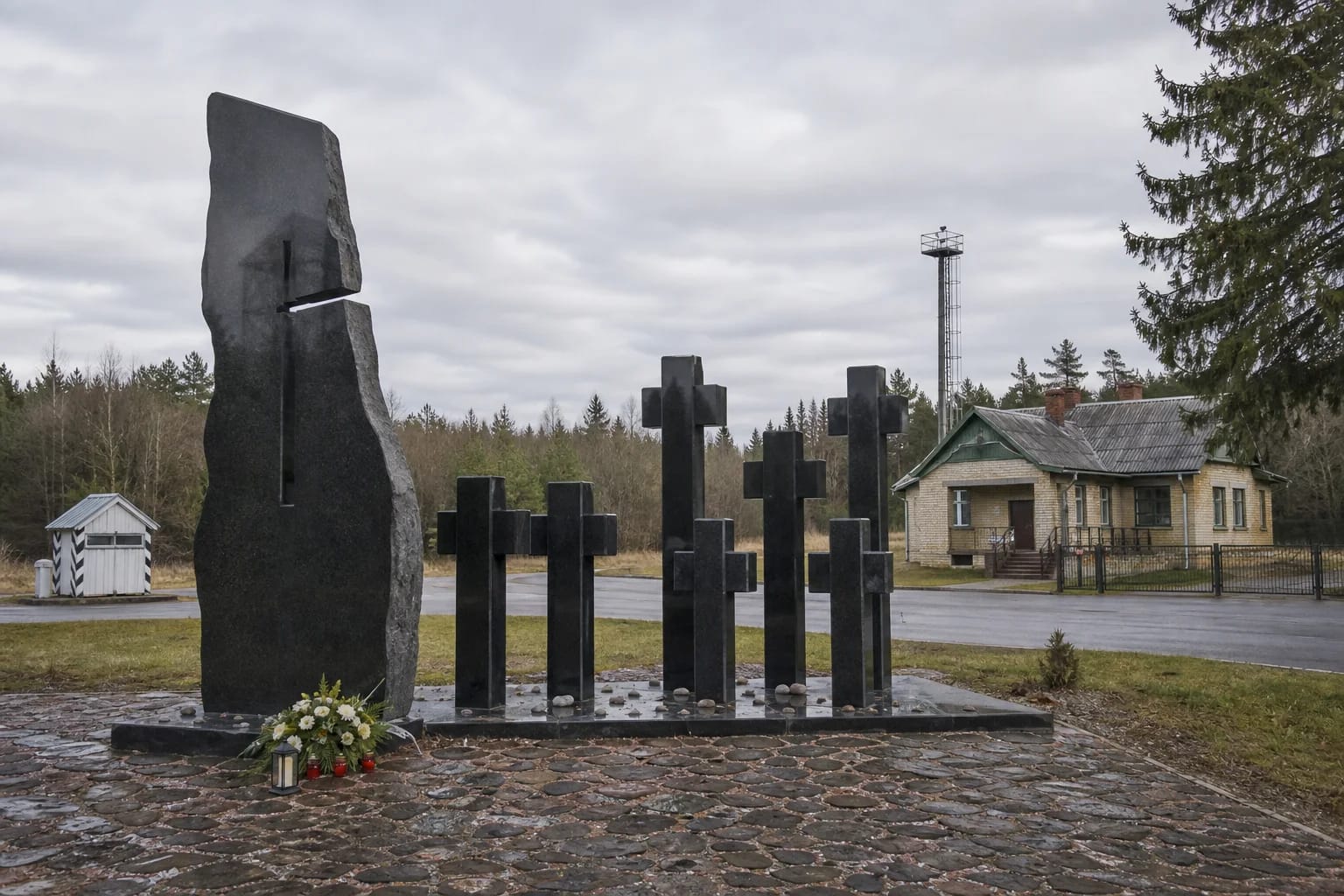 Black granite Medininkai Tragedy Memorial with seven crosses