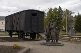 Railcar and sculpture of the Naujoji Vilnia Deportation Memorial by the railway station in Vilnius