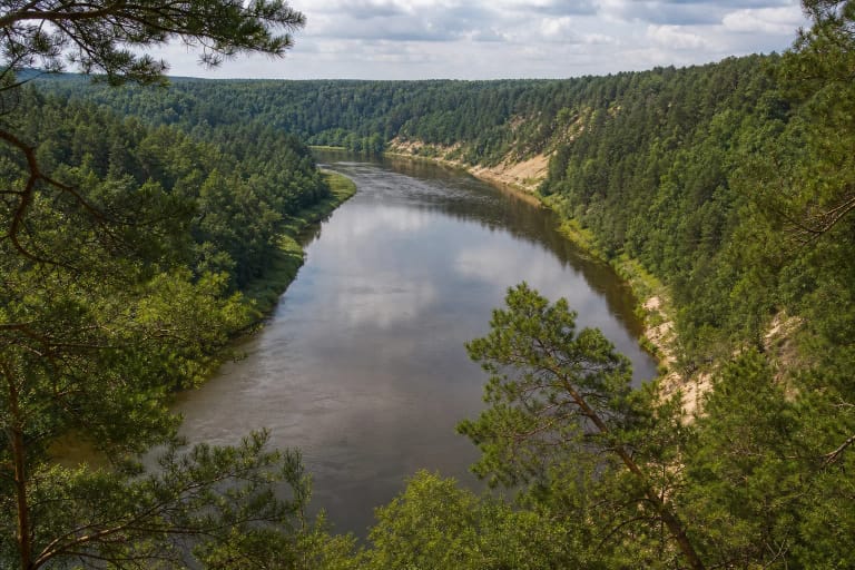 Scarps of Neris Regional Park and a winding river between wooded slopes