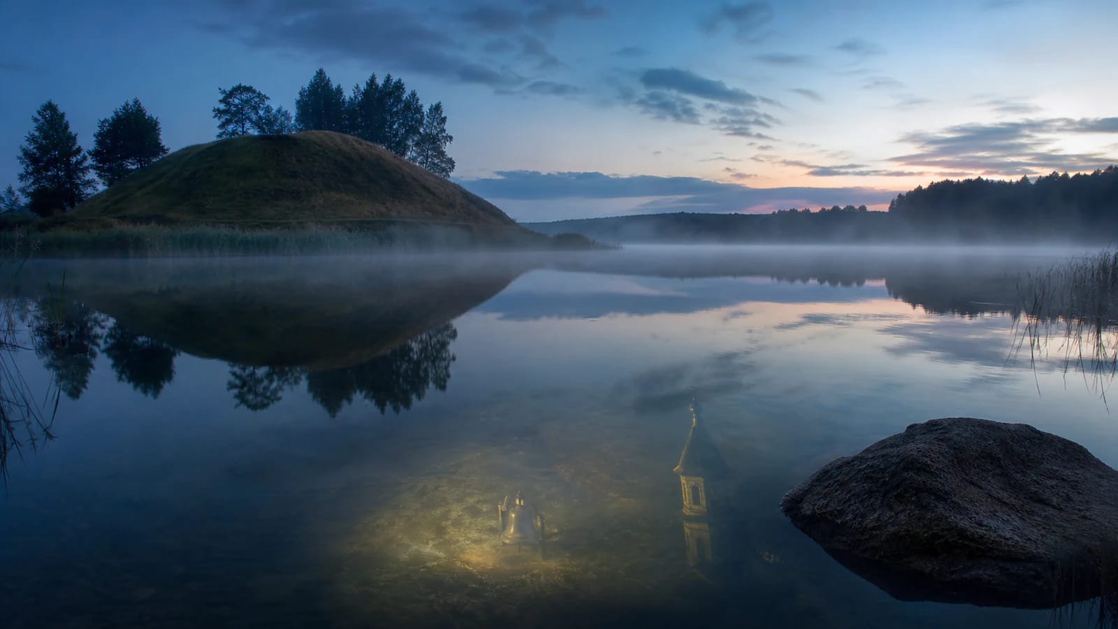 A hillfort rises by Lake Obelija, as if the bells of a hidden church could be heard through the mist