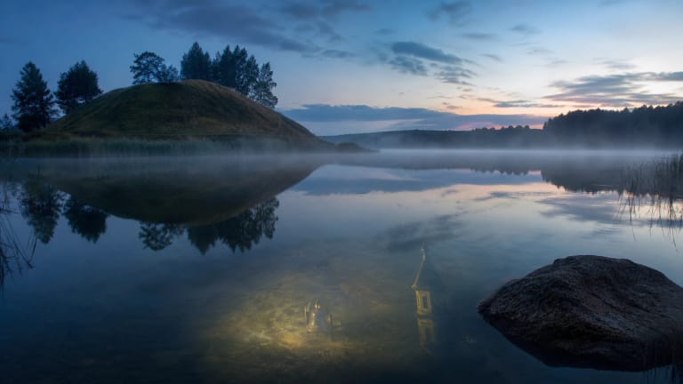 A hillfort rises by Lake Obelija, as if the bells of a hidden church could be heard through the mist