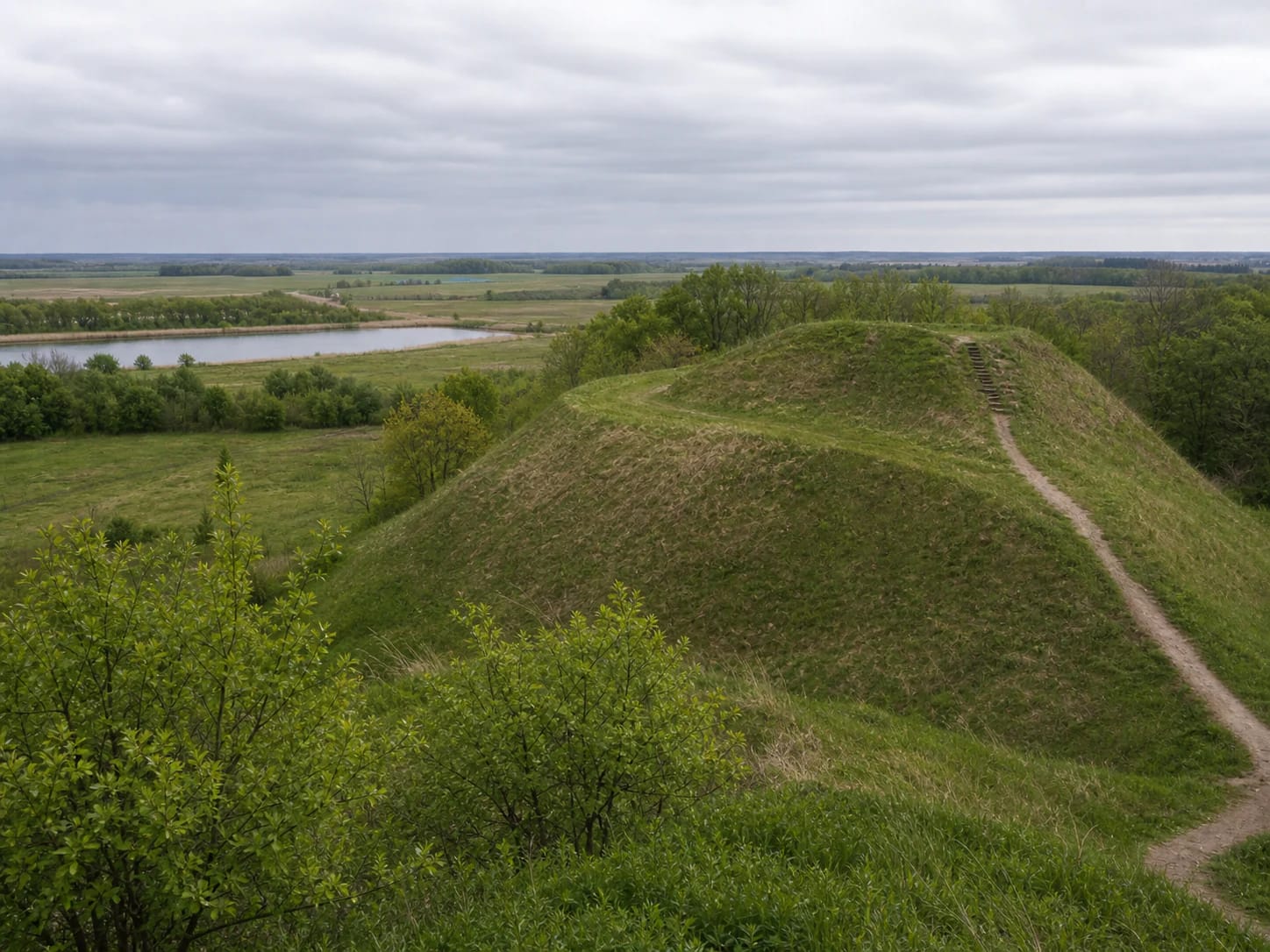 Green slope and path of Opstainiai (Vilkyškiai) Hillfort in the landscape of Rambynas Regional Park