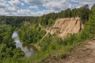 Vilnia River valley in Pavilniai Regional Park with the cliff of Pūčkoriai Outcrop
