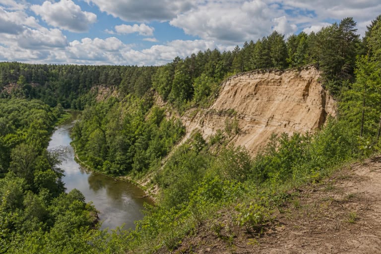 Vilnia River valley in Pavilniai Regional Park with the cliff of Pūčkoriai Outcrop