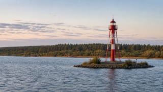 Pervalka Lighthouse in the Curonian Lagoon on a small artificial islet by Žirgai Cape, seen from Pervalka shore on calm evening water