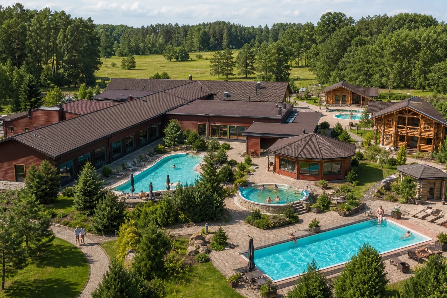 Bright Atostogų Park pool hall with an arched water feature and loungers