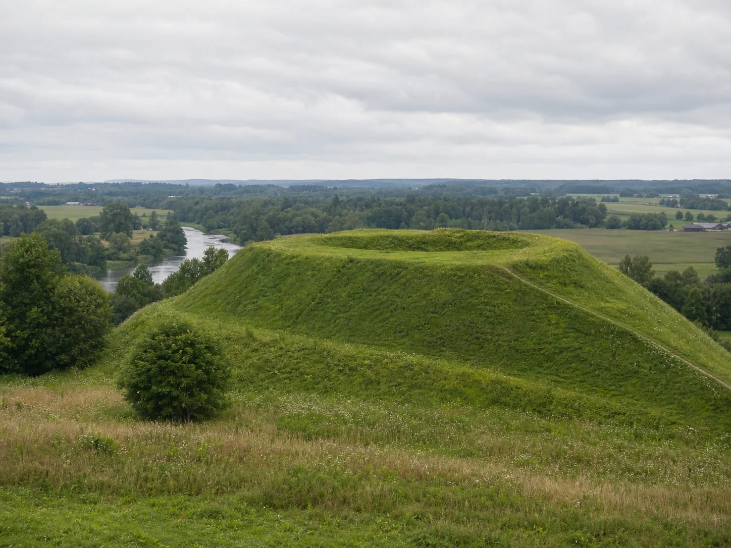 Green rampart and path at Puodkaliai Hillfort near the Bartuva and Erla confluence