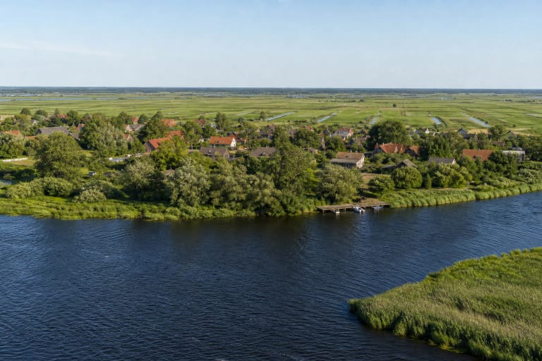 Rusnė Island plains, a winding Nemunas Delta river, reedbeds, and a red-roofed settlement in summer