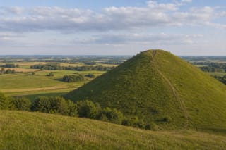 Šatrija Hill with steep green slopes and a panorama of Samogitian fields