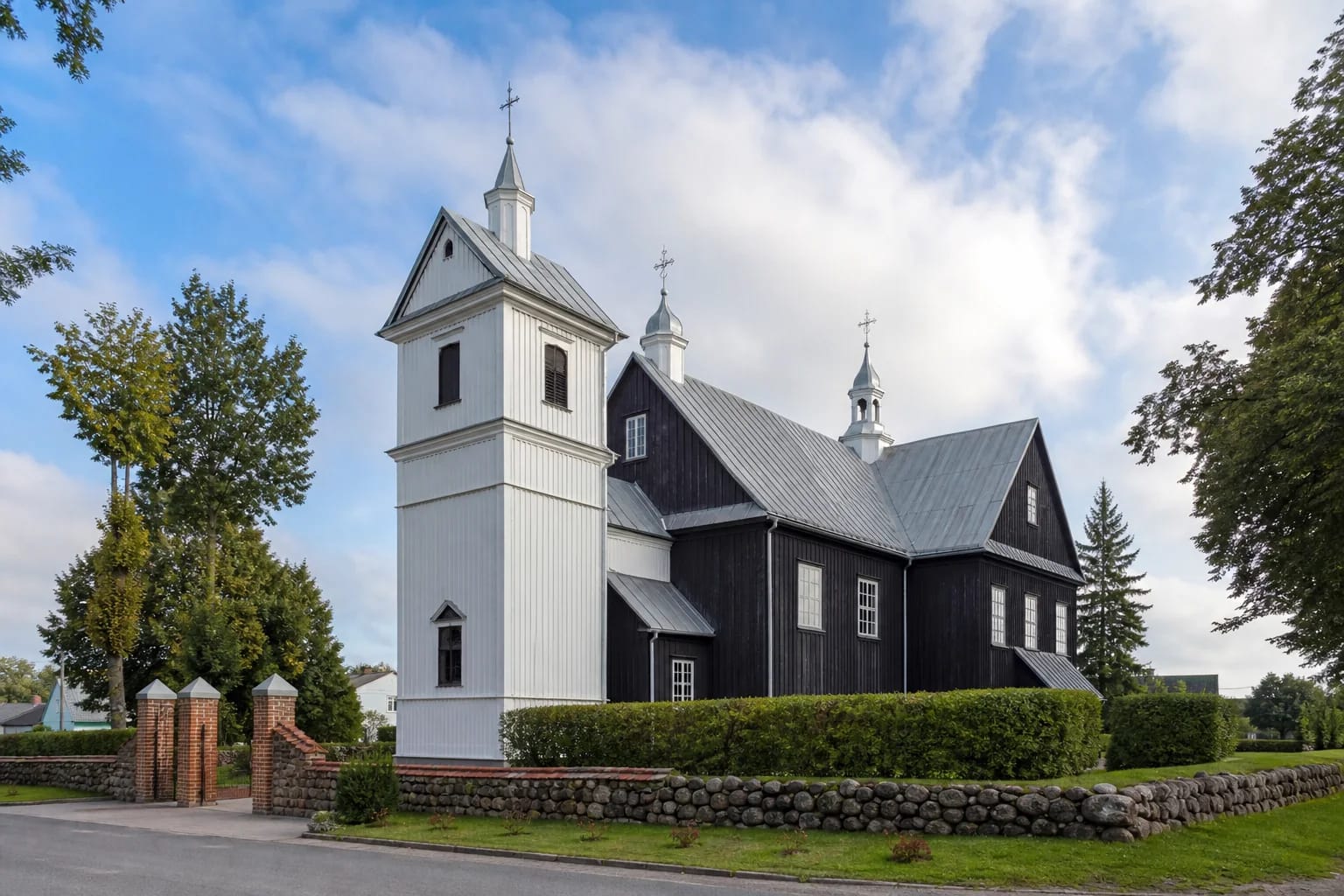 The large wooden Seda Church with steep roofs and small towers in Mažeikiai District