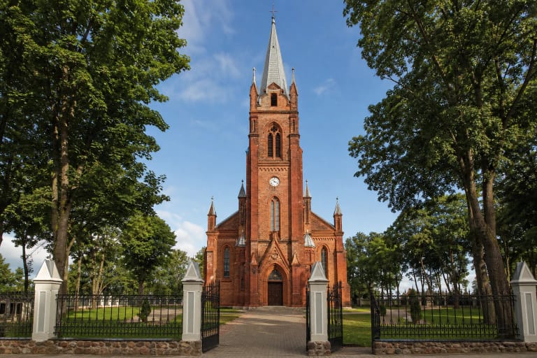 The red-brick Church of St Francis of Assisi in Šilalė rising to a very tall pointed tower