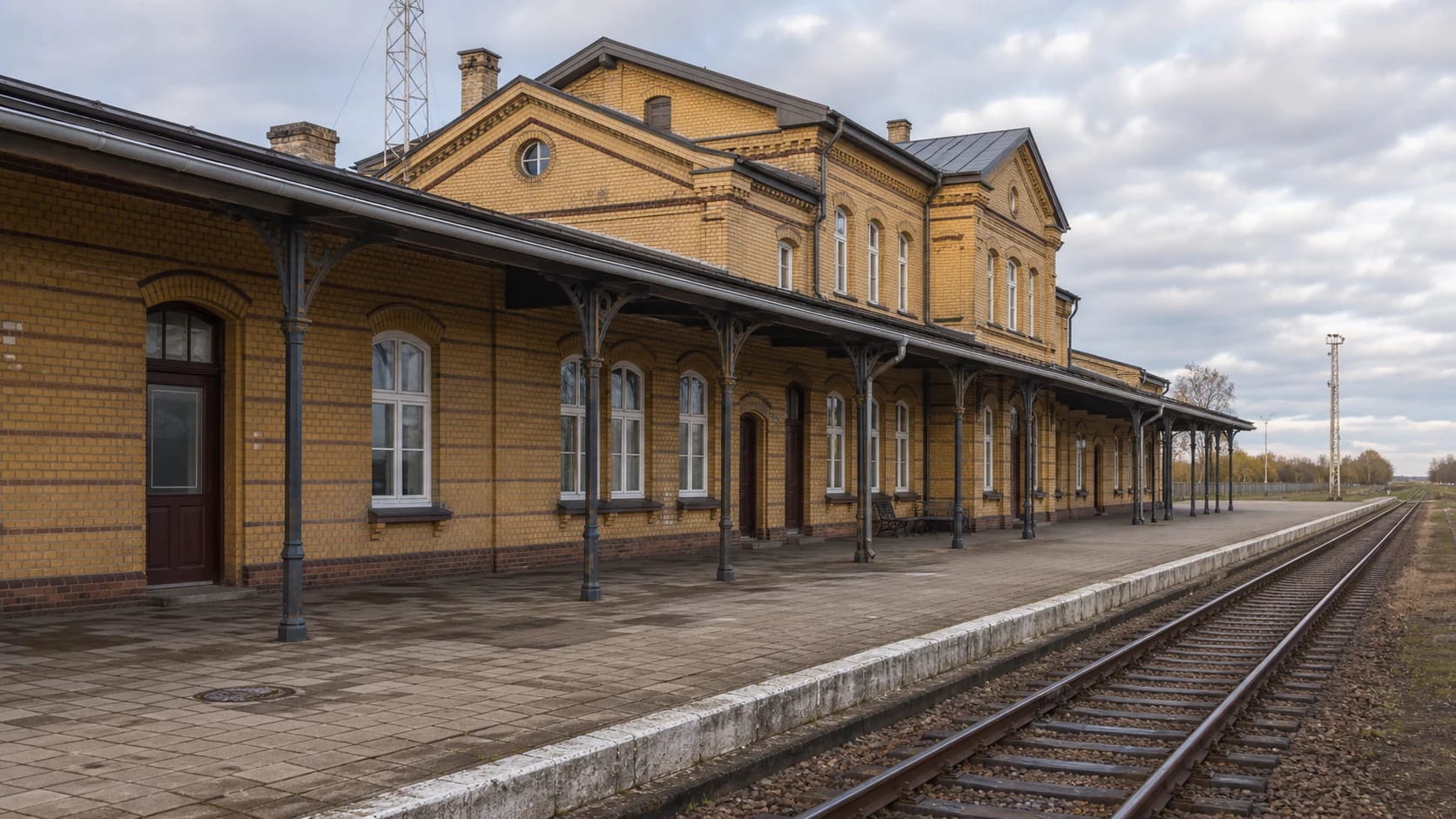 Yellow-brick building of Šilutė Railway Station with the platform canopy