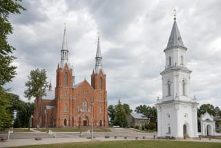 Šiluva Shrine square with red-brick basilica and white Apparition Chapel