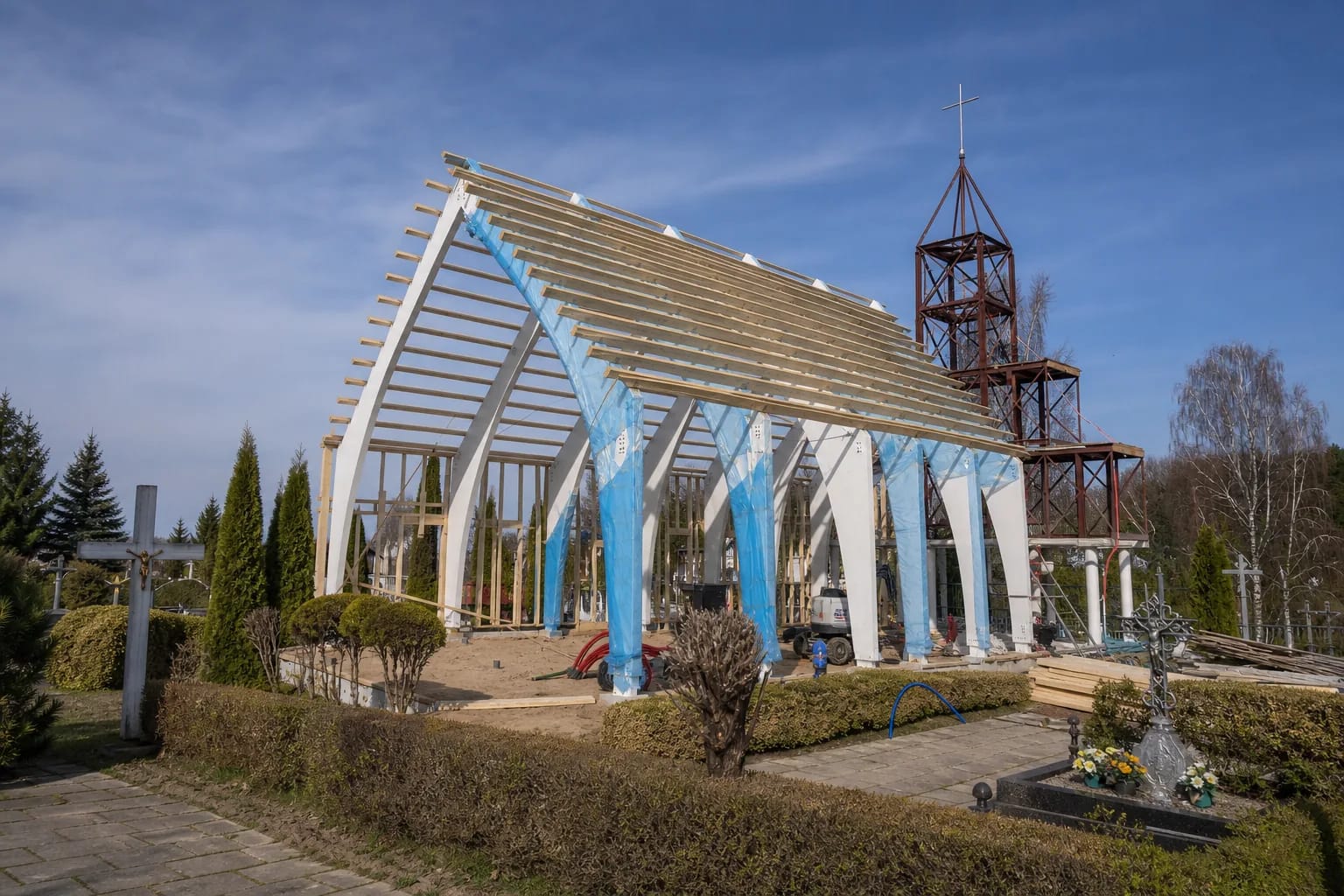 Construction site of the new Šlienava church on the former sanctuary's footprint, with structural work rising above the foundations