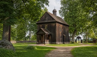 Wooden Stelmužė Church of the Cross of the Lord Jesus in the manor-estate setting