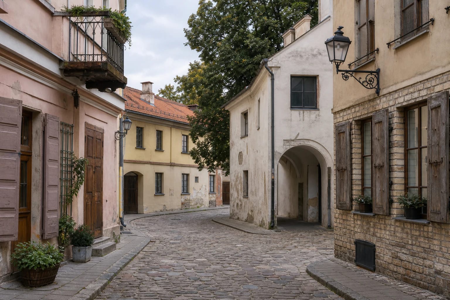 Narrow street in Vilnius Old Town's Glass Quarter with historic facades and stone paving