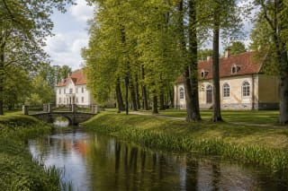 Švėkšna Manor park alley, historic buildings, and ponds in a green town landscape