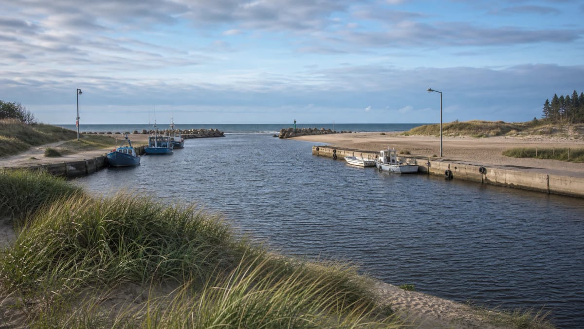 Šventoji port and river mouth area with breakwaters and the Baltic Sea horizon