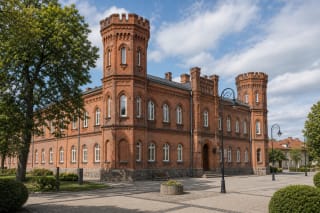 Red-brick towers of Tauragė Castle with loophole-like openings and the Santaka Museum facade in the city centre